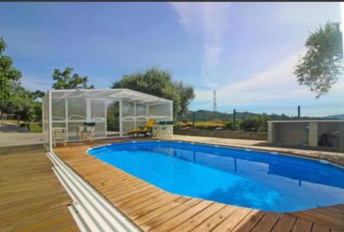 a house with a swimming pool and a glass house at Casa Ze da Cotta in Vila Verde