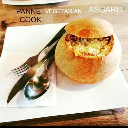 a sandwich on a white plate with a fork and spoon at ASGARD Spa in San Agustín
