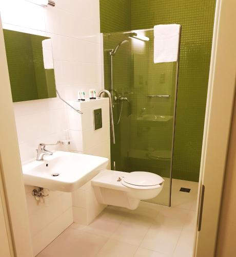 a bathroom with a sink toilet and a shower at Hotel Willa Odkrywców in Szklarska Poręba