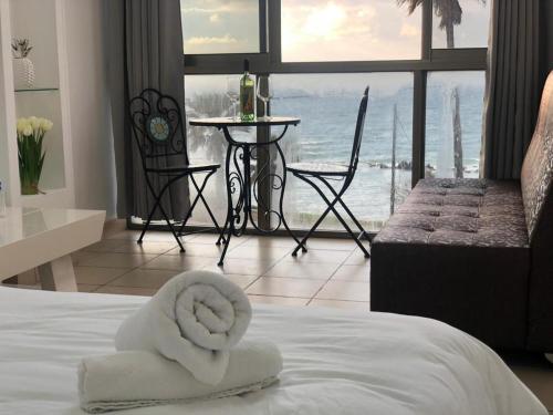 a hotel room with a bed with a towel on it at Sea Line Hotel From R&A Group in Bat Yam