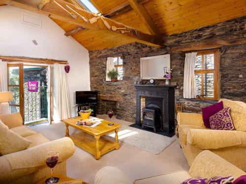 a living room with couches and a fireplace at Bakestones - Central Location with Free Integral Private Parking in Ambleside