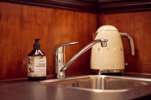 a bottle of soap sitting next to a kitchen sink at Realeneiland Bed & Breakfast in Amsterdam
