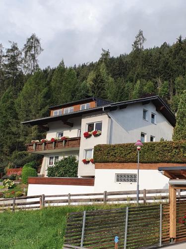 a white house with plants on the side of it at Haus Wohleb in Fulpmes