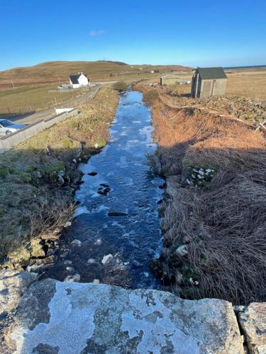 an aerial view of a river in a field at The Bridge Self Catering in Kilmaluag