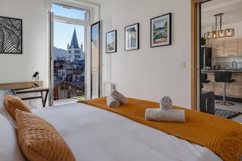 a bedroom with a large bed with towels on it at Le Balcon Annécien 4 - rooftop view for 2-4 people in Annecy