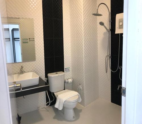 a bathroom with a toilet and a sink and a shower at P Bliss hotel in Phayao