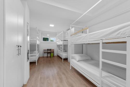a room with two bunk beds and a desk at Hostel Elli in Split
