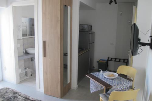 a small dining room with a table and chairs at Kasamare apartments in Cefalù