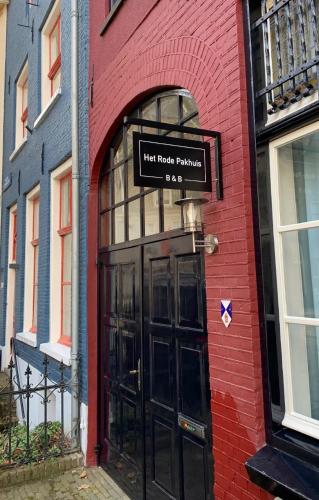 a door to a brick building with a sign above it at Het Rode Pakhuis in Doesburg