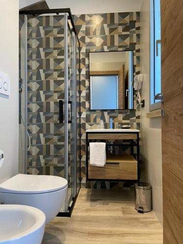 a bathroom with a toilet and a sink and a mirror at Bari Airport Rooms in Bari