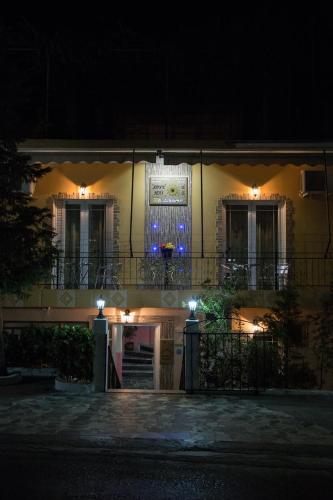 a building with a lit up door at night at Golden Sun Rooms in Pyrgi Thermis