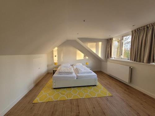 a bedroom with a bed and a yellow rug at De Egel in Oostkapelle