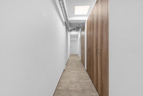 a hallway with white walls and a long corridor at Hostel Elli in Split