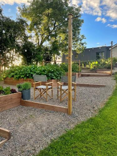 a garden with two chairs and a table at The Hideaway Retreat in Omagh