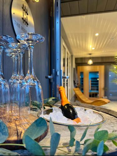 a table with wine glasses and a bird on a plate at The Hideaway Retreat in Omagh
