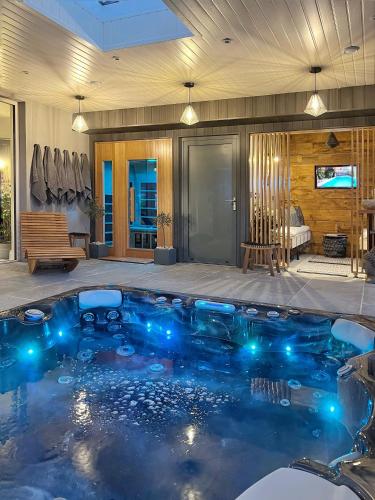 a swimming pool with blue lights in a house at The Hideaway Retreat in Omagh