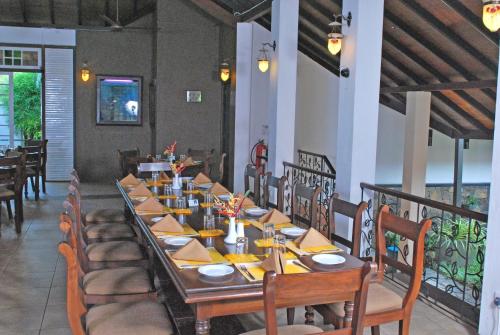 a long dining room with a long table and chairs at Nature Trails Boutique Hotel in Unawatuna