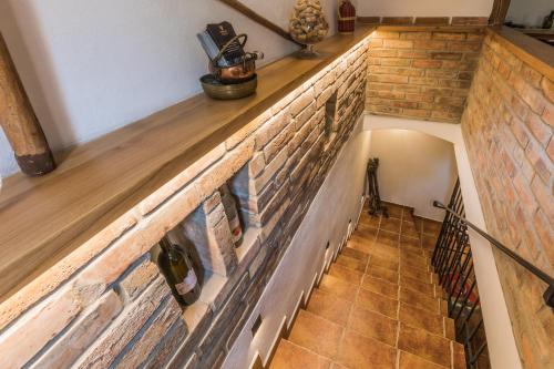 a staircase in a house with a brick wall at Vinoza - ubytování a vinný sklep v Moravském Toskánsku in Hovorany