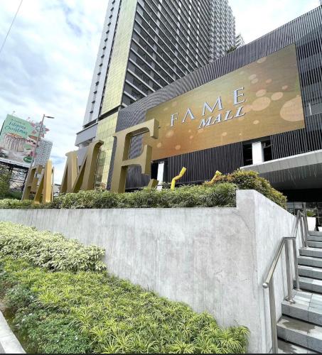 a sign for a fancy mall in front of a building at Staycation in Manila
