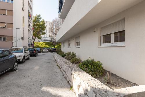 a street with cars parked on the side of a building at Hostel Elli in Split