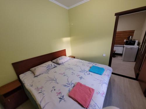 a bedroom with a bed with two towels on it at База відпочинку "Тростян" in Slavske