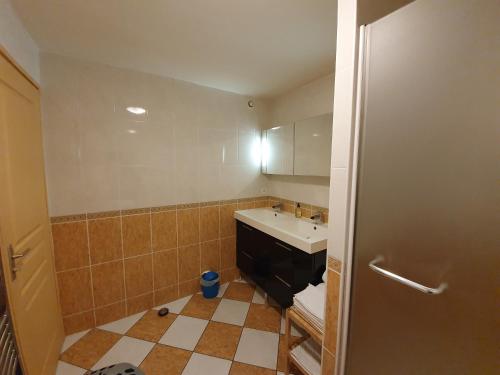 a small bathroom with a sink and a mirror at 3 Allée de l'Orée du Lac in Biarritz