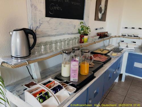 a kitchen counter with two bottles of juice and glasses at Hostel Hof Kranichstein in Kluis