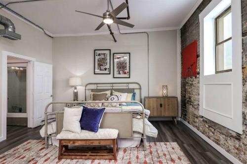 a bedroom with a bed and a ceiling fan at Dottie's Loft 202 in Longview