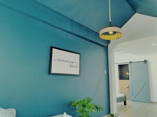 a room with a blue wall with a picture on it at Room in Vung Tau- Blue Fish Deluxe Room- Phòng Bãi Sau Vũng Tàu in Vung Tau
