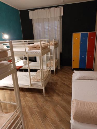 a dorm room with two bunk beds in it at Gloria Hostel Milano in Milan