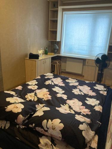 a bedroom with a bed with a black and white blanket at Find for the traveler in Tallinn