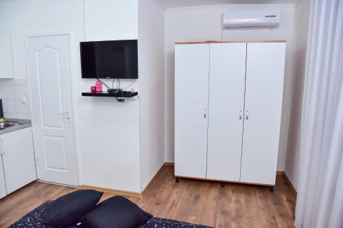 a room with a white cabinet with a tv on it at Apartmani Koko in Banja Luka