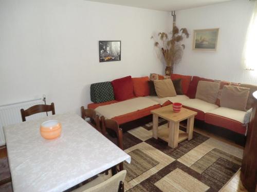 a living room with a couch and a table at Holiday Home Minja in Kopaonik