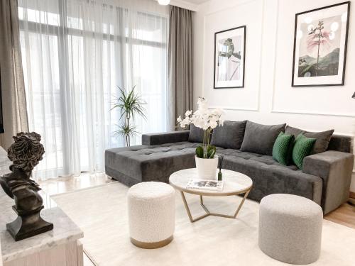 a living room with a couch and a table at Lolita Lux - Belgrade Waterfront in Belgrade
