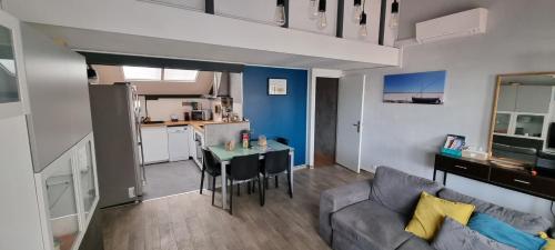 un salon avec un canapé et une table dans l'établissement Maison 3 pièces 5-7pers Vue sur port, garage, clim, à Gruissan