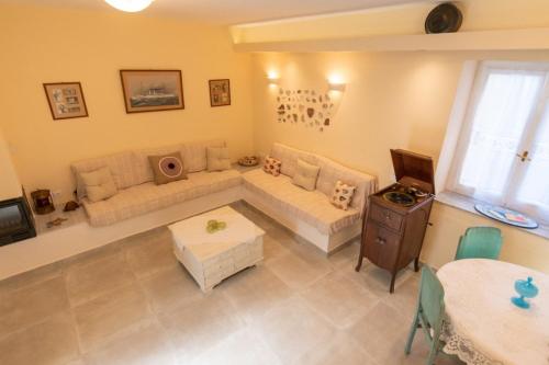 a living room with a couch and a table at La belle Hélène in Spetses