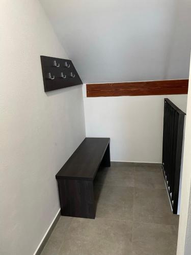 a room with a bench in the corner of a room at Apartmán D5 Nová Pec in Nová Pec