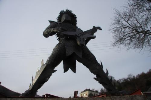 a statue of a dragon sitting on top of a tree at Gîte des trois vallees in Nouzonville