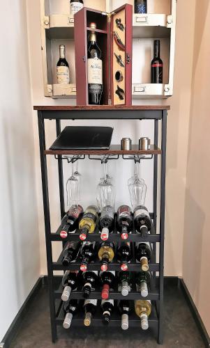 a wine rack with bottles and glasses on it at FEWO am Neuen Dom in Linz
