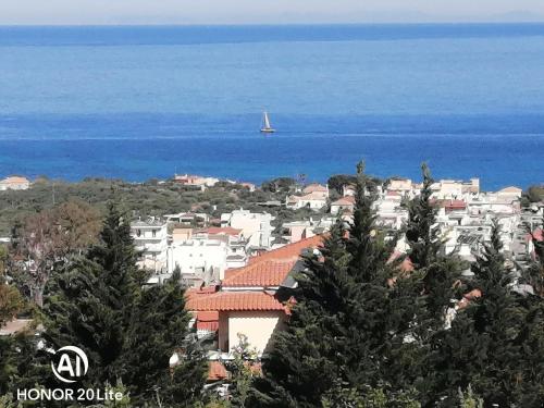 a view of a city with a boat in the water at Villa Myrto in Kyparissia