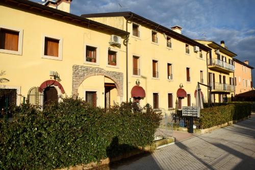 a large white building with a fence in front of it at Casa Giulia - Tramonto - Valeggio sul Mincio in Valeggio sul Mincio