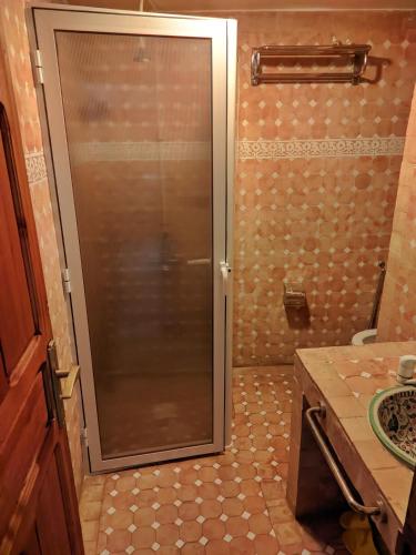 a shower with a glass door in a bathroom at Riad Fes Touria Palace in Fès