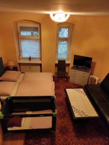 a bedroom with two beds and a desk and a computer at Hotel Gunia in Berlin