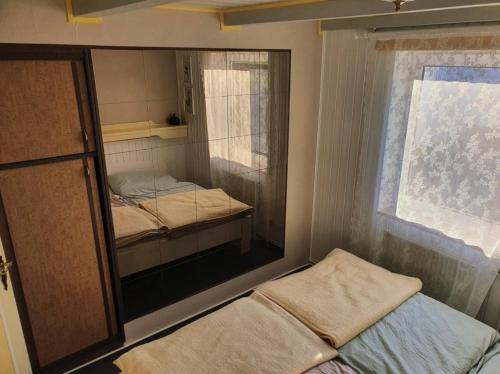 a small room with two beds and a window at Ferienwohnung Daliah in Wangels