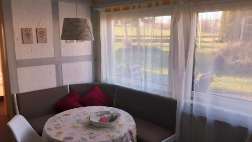 a room with a table and a table and a window at Ferienwohnung Daliah in Wangels