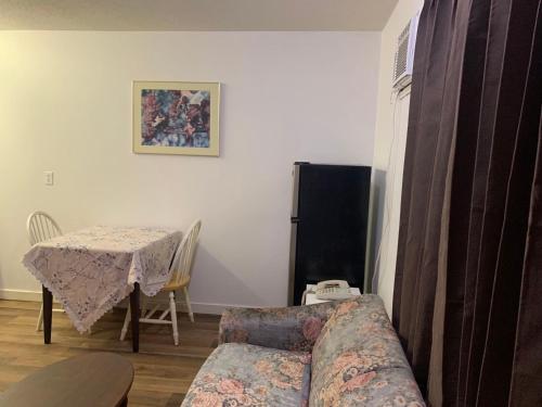 a living room with a couch and a table at Swiss Sunset Inn in Penticton