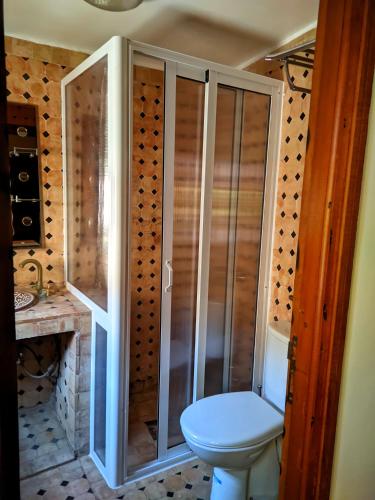 a bathroom with a toilet and a glass shower at Riad Fes Touria Palace in Fès
