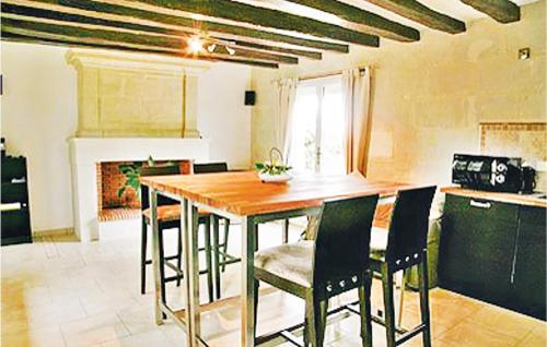 a kitchen with a wooden table and chairs at Lovely Home In Saumur With Wifi in Saumur