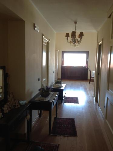 a living room with a table and a chandelier at Glamour Bed & Breakfast in Montalto Uffugo