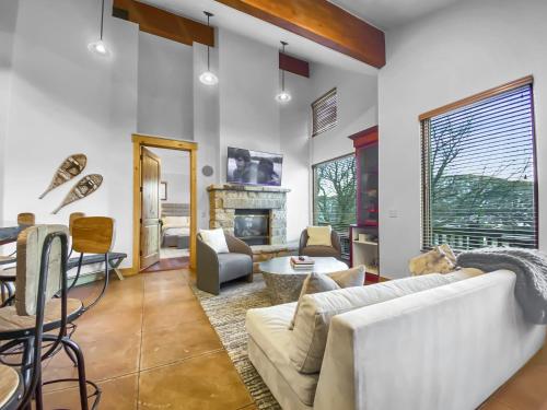 a living room with a couch and a fireplace at 502 A Gold Coast! townhouse in Park City
